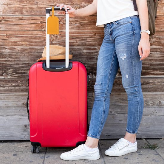 travelhawk bagagelabels bevestigd aan kofferhandvat